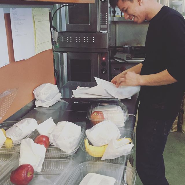 Behind the Scenes at Yali's Cafe: Hard work at Yali's doesn't mean a lack of fun! Ray, one of our amazing cooks, smiles as he puts together some lunch boxes for a catering order. Looking to order something for an event or meeting? Go to yaliscafe.com for our menu and online ordering form!